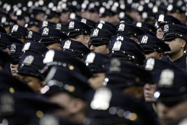 Dozens of new police officers, with their heads with NYPD hats somewhat obscured, can be seen in the photographer
